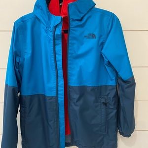 The North Face winter jacket. Blue with red interior.